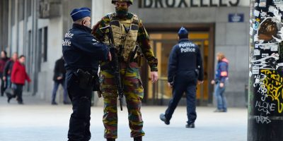 TOPSHOT-BELGIUM-ATTACKS TOPSHOT - A Belgian soldier speaks to a police officer outside Brussels Central Station as people are allowed in small groups of ten to reach the station in order to take their commuter train following attacks in Brussels on March 22, 2016.
Airlines cancelled hundreds of flights and European railways froze links with Brussels after a series of bombs blasts killed around 35 people in the city's airport and a metro train, sparking a broad security response. / AFP / EMMANUEL DUNAND (Photo credit should read EMMANUEL DUNAND/AFP/Getty Images)